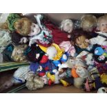 A large quantity of dressed dolls and a collection of dressed, ceramic headed clowns.