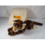 Steiff - A Steiff Tierleben Tiger entitled Radjah with button in ear and label, drawstring bag,