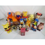 A good lot to include seventeen money boxes to include Winnie the Pooh, Mickie Mouse, Donald Duck,