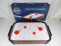 A boxed table top air hockey game