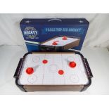 A boxed table top air hockey game