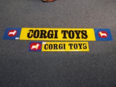 Corgi - two Corgi Toys advertising signs,