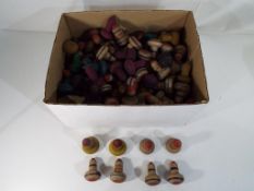A large quantity of vintage wooden spinning tops.