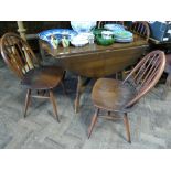 4' Ercol oak drop leaf dining table and four similar stick back Windsor style chairs