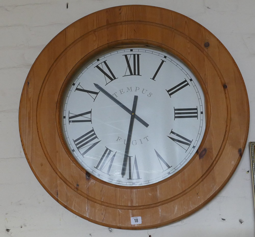 Large circular wall clock in pine frame