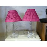 Pair of modern glass bedside lamps with fitted pink shades