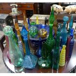 Large qty of coloured glass decanters, bottles, bowls, floats etc.