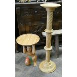 Pale wood twist column torchere and a painted carved wooden figure coffee table