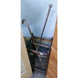 Old stick stand with 2 sticks and a picture firescreen