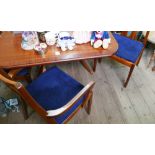 Dark teak extending dining table with four standard chairs and 2 carvers