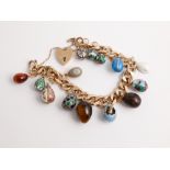 9ct gold curb link charm bracelet set with 14 Faberge style egg charms to include tigers eye, agate,