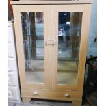 Lightwood glass display cabinet with one drawer under