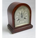 Edwardian striking mantel clock with arched silver dial in mahogany case