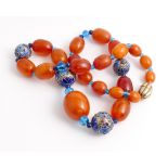 Graduated amber bead necklace with silver and cloisonne enamel beads. Largest bead measures 2.