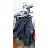 Set of Wilson 1200 golf clubs in a black golf bag with woods and folding trolley etc.