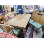 Large heavy oak extending table with one leaf and six matching chairs,