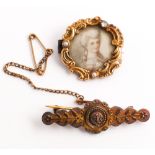 Antique brooch with portrait miniature to the centre of a lady painted on ivory panel in a scrolled