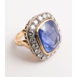 Large and impressive sapphire and diamond cluster ring set with a pale blue sapphire in excess of