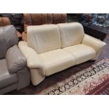 A Ekornes stress less 2 seater reclining settee in soft cream leather