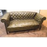 Antique green leather buttoned Chesterfield drop end settee seat in worn condition