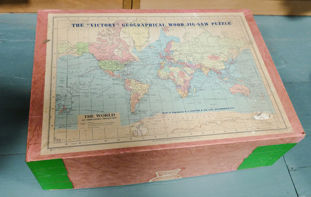 Vintage wooden jigsaw of the World and a tin jack in the box