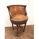 A French swivel tub shaped desk chair with circular seat in double cane panels