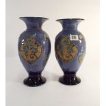 A pair of blue Doulton vases decorated with anemones 27cms tall impressed marks to both bases