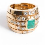 A large and impressive emerald and diamond cluster ring set in a large modern band design ring size