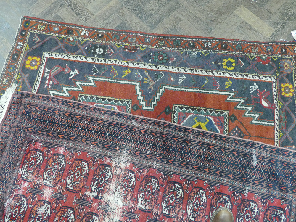 Hand woven Persian rug on blue and Burgundy ground with bird motifs to the central panel together