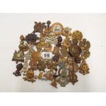 Collection of military cap badges and shoulder titles to include army cyclists, Royal Engineers,