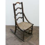 A ladder back rocking chair with rush seat