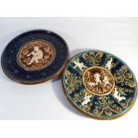 Pair of Austrian relief moulded wall plates, one painted with Leprechauns,