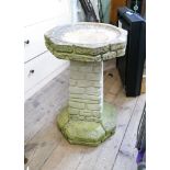 A stone effect garden bird bath