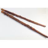 Pair of carved wood walking sticks