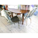 Circular mahogany table and four wheel back dining chairs