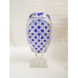 A Bohemian cut glass vase overlaid with dark blue standing on a square base 35cms x 20cms