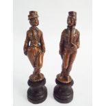Pair of small bronze figurines in 18th century costume on turned wooden bases height 15cm
