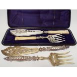 A boxed set of silver plated and ivory handled fish servers together with another pair with
