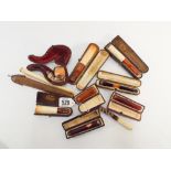 A collection of Victorian and later boxed Cheroot holders some with amber stems