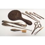 A collection of silver handled button hooks, shoe horns,