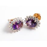 A pair of amethyst and diamond cluster ear studs set oval amethyst of approx 4 ct surrounded by