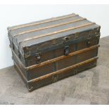 A large canvass wood and metal bound trunk