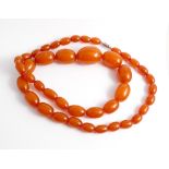 A row of vintage graduated amber beads,