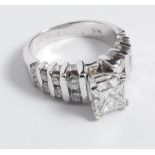 A 14ct white gold diamond ring set with a princess cut diamond and diamond set shoulders ring size