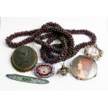 A multiple row of garnet beads and a collection of vintage brooches to include lava cameo brooch