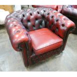 A Chesterfield style tub shaped easy chair in buttoned red leather