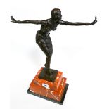 Contemporary bronze after Chiparus of a semi clad dancing girl on a rouge marble base