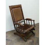 American walnut framed rocking elbow chair upholstered in brown dralon