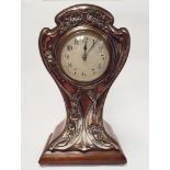 An Art Nouveau Mahogany balloon clock with silver faced floral panels to the front 31.