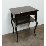 A 2 tier Edwardian mahogany folding top card table with under tier standing on cabriole style legs